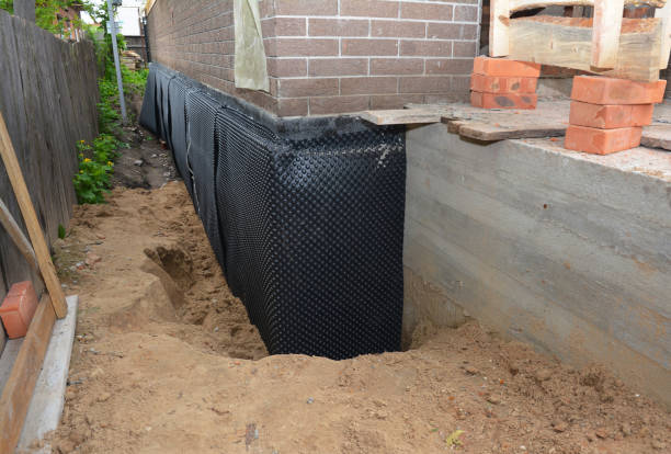 SJ Waterproofing Pros technician performing targeted Exterior Waterproofing assessment in Springfield, MI
